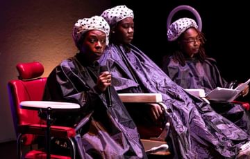 Young people sit in hairdressing chairs surrounded by halo lights