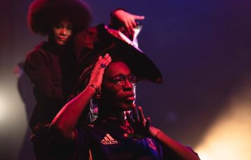 Two young people perform in a show set in a hair salon