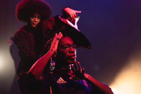 Two young people perform in a show set in a hair salon