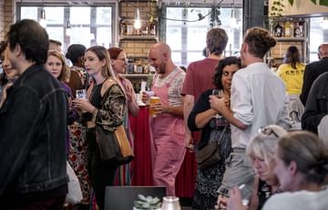 A crowd socialising around the cafe.