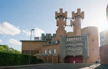 Contact's castle-like exterior with bright blue skies surrounding it