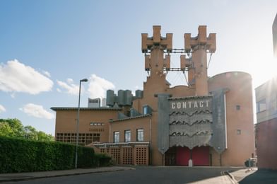 Contact's castle-like exterior with bright blue skies surrounding it