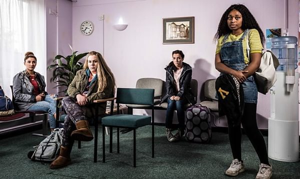 A group of women wait anxiously in a hospital waiting room