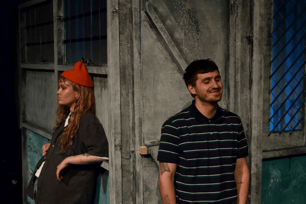 Rory Aaron and Kate Ireland perform on stage in a pub setting